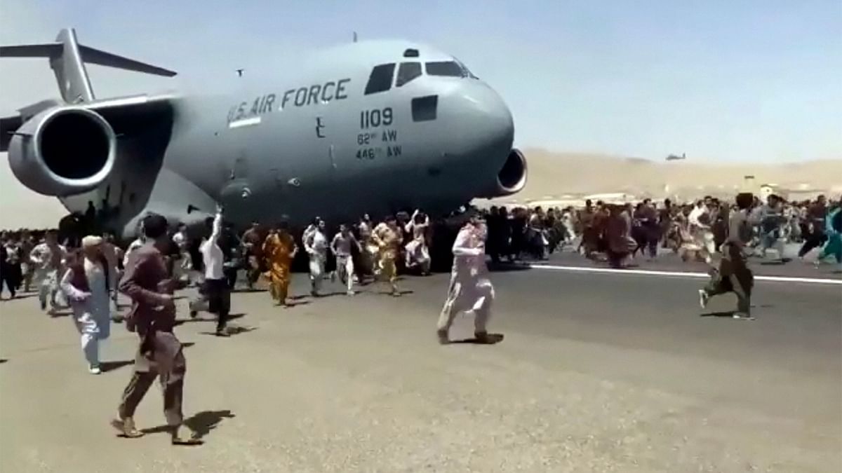 Some clung to the side of a US military transport plane before takeoff, in a widely shared video that captured the sense of desperation as America's 20-year war comes to a chaotic end. Credit: AP Photo