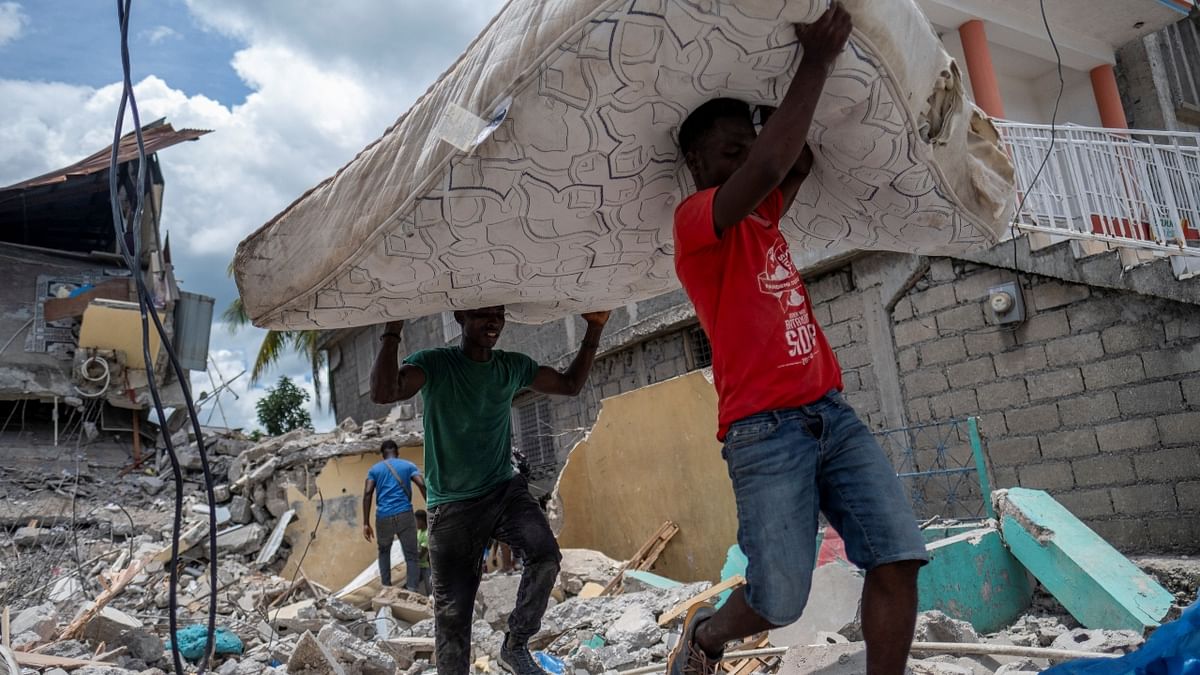 In Les Cayes, as in other hard-hit cities on the southwestern peninsula, most of the population spent the night sleeping outdoors in front of their houses -- or what remained of them -- amid fears of new aftershocks. Credit: Reuters Photo