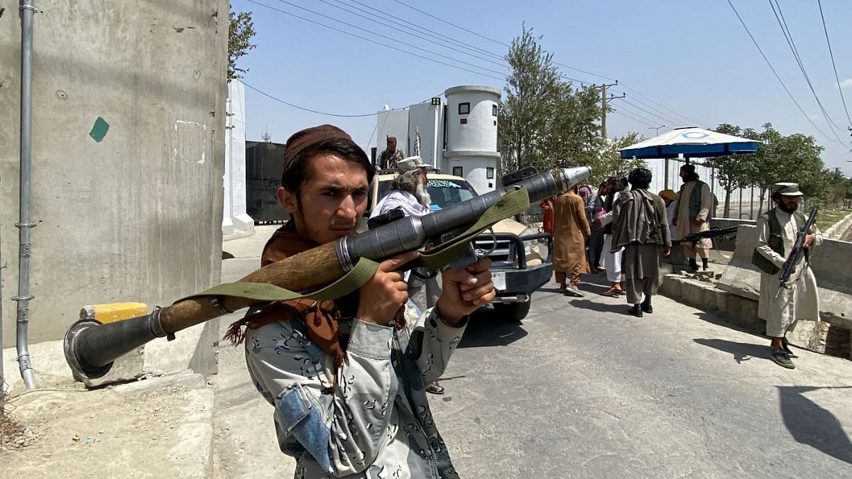 A Taliban fighter holds RPG rocket propelled as he stands guard with others at an entrance gate outside the Interior Ministry in Kabul. Credit: AFP Photo