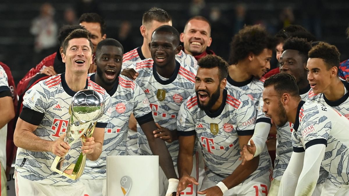 Bayern Munich's players celebrate with the trophy after defeating Borussia Dortmund to the German Supercup. Credit: AFP Photo