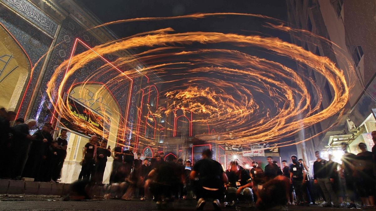 Iraqi Shiites take part in a religious procession during the month of Muharram leading up to the mourning day of Ashura, in the holy city of Najaf. Credit: AFP Photo