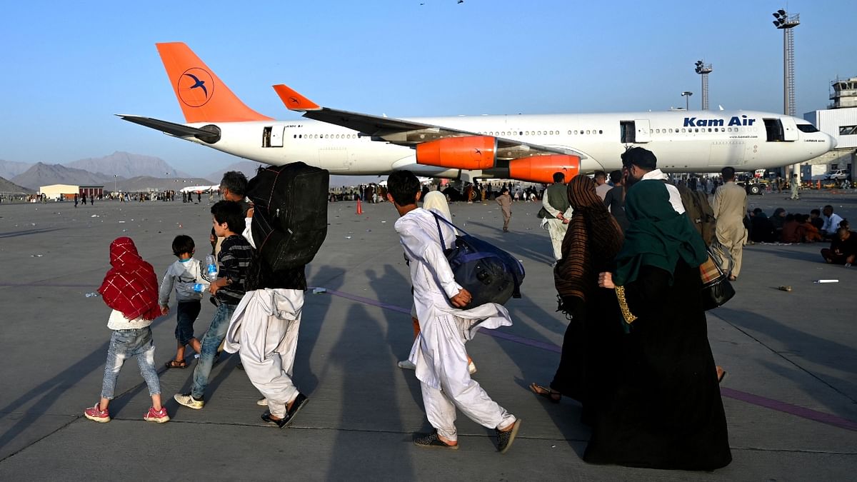 Afghan families at the Kabul airport. Credit: AFP Photo