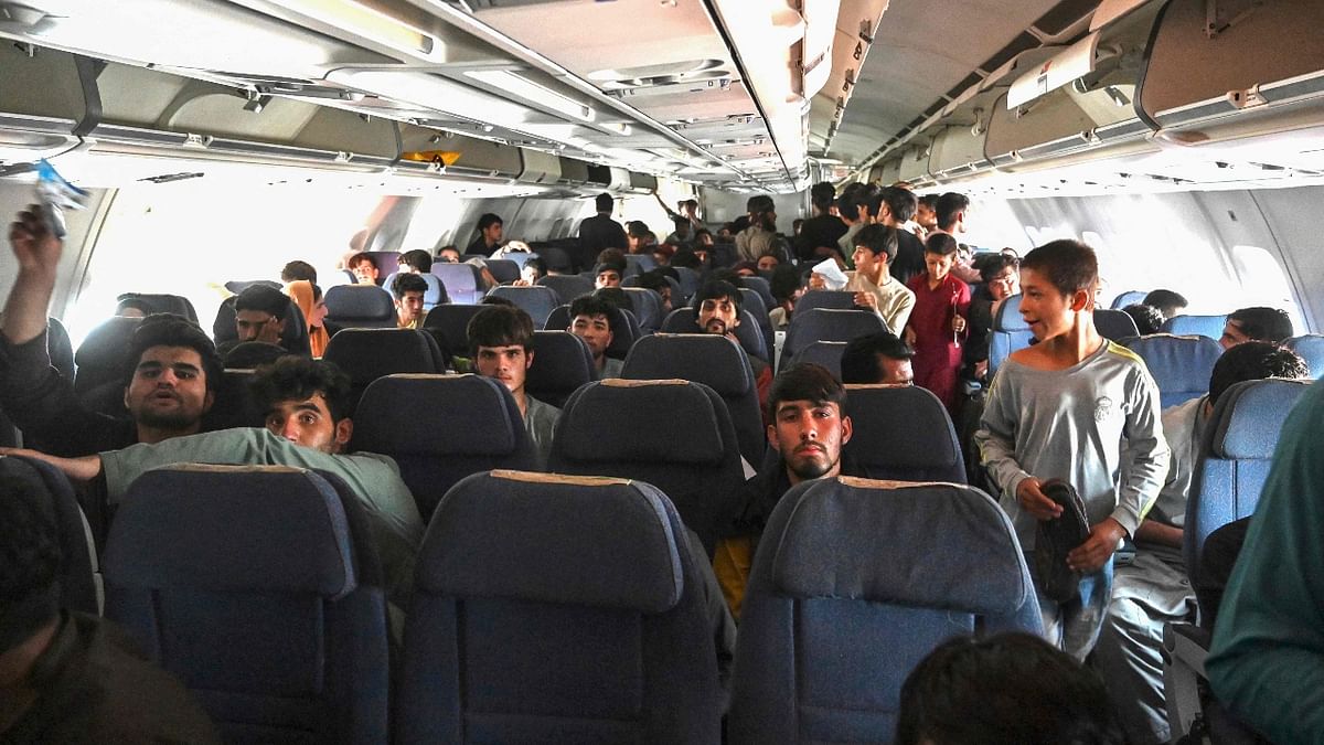 Afghan passengers sit inside a plane as they flee Kabul after a stunningly swift end to Afghanistan's 20-year war. Credit: AFP Photo