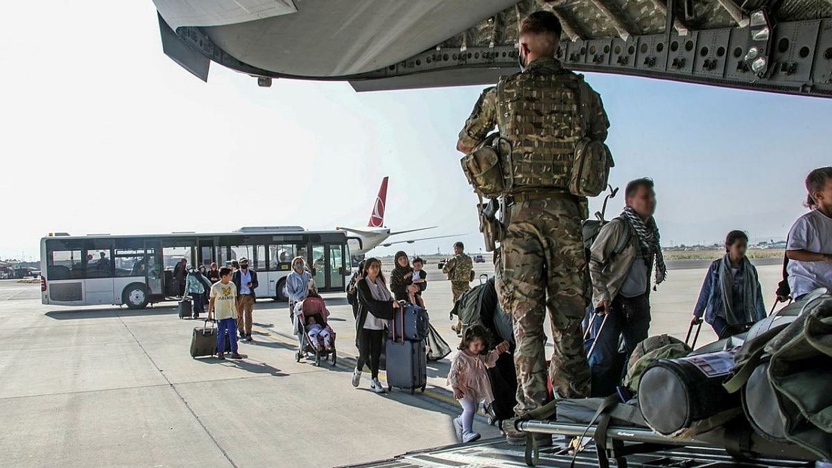 British citizens and dual nationals residing in Afghanistan board a military plane for evacuation from Kabul airport, Afghanistan. Credit: Reuters Photo