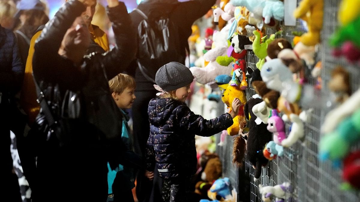 Children look at soft toys on a fence in front of the government building during a protest against government's vaccination policies in Riga, Latvia. Credit: Reuters Photo