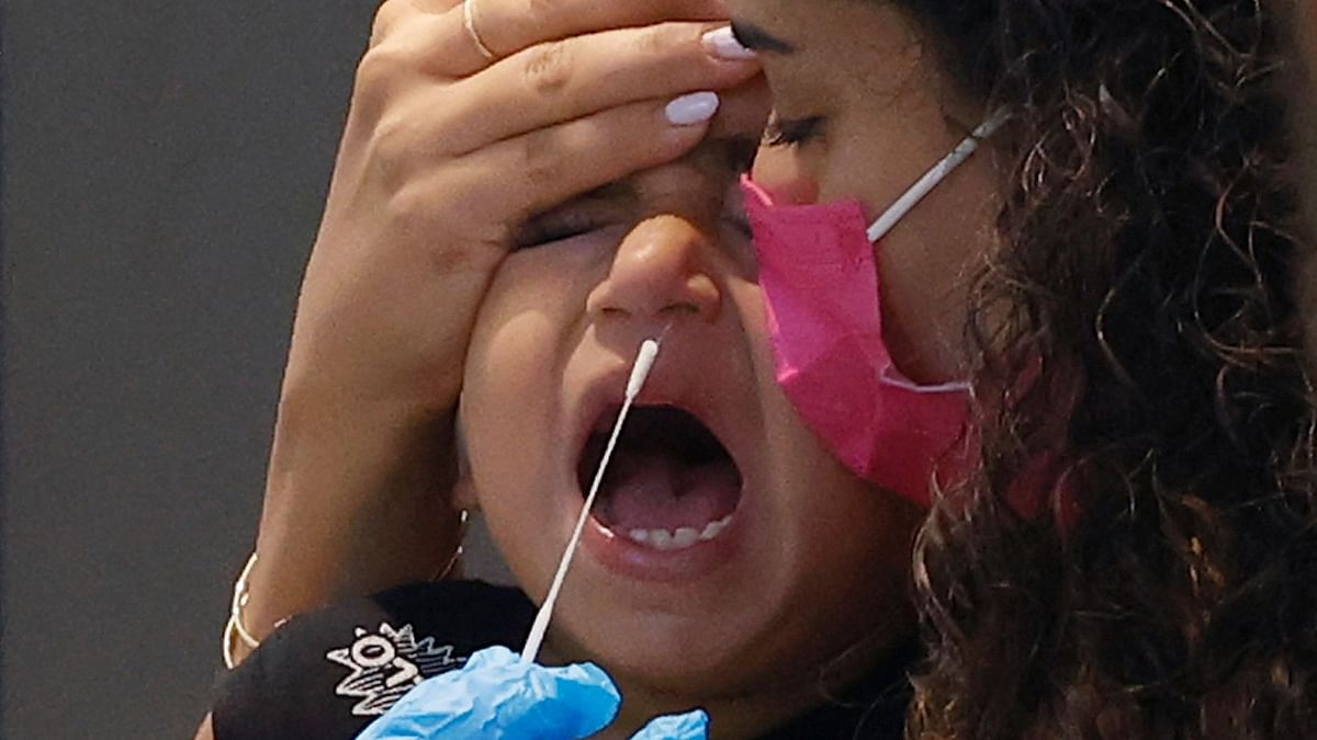 A child cries while undergoing an antigen test in Israel. Credit: AFP Photo