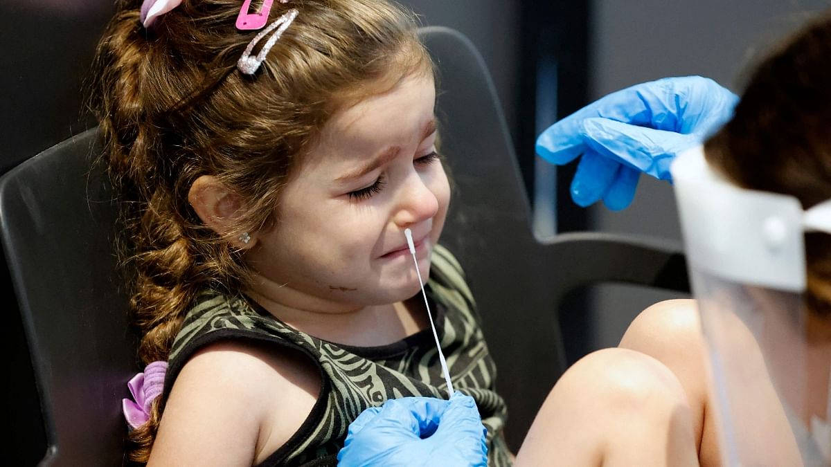 An Israeli child prepares herself to undergo an antigen test in order to visit an exhibition in Tel Aviv. Credit: AFP Photo