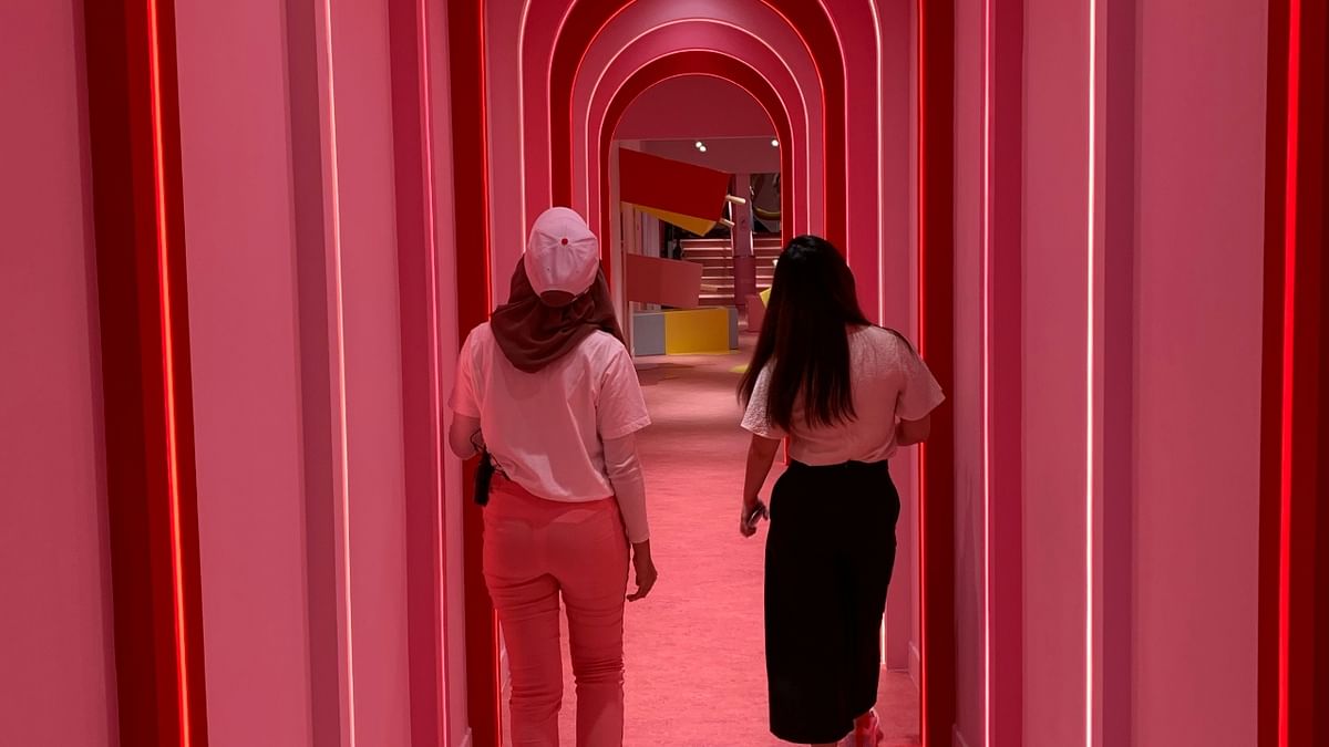 People walk through a hallway light exhibit at the Museum of Ice Cream in Singapore. Credit: Reuters Photo