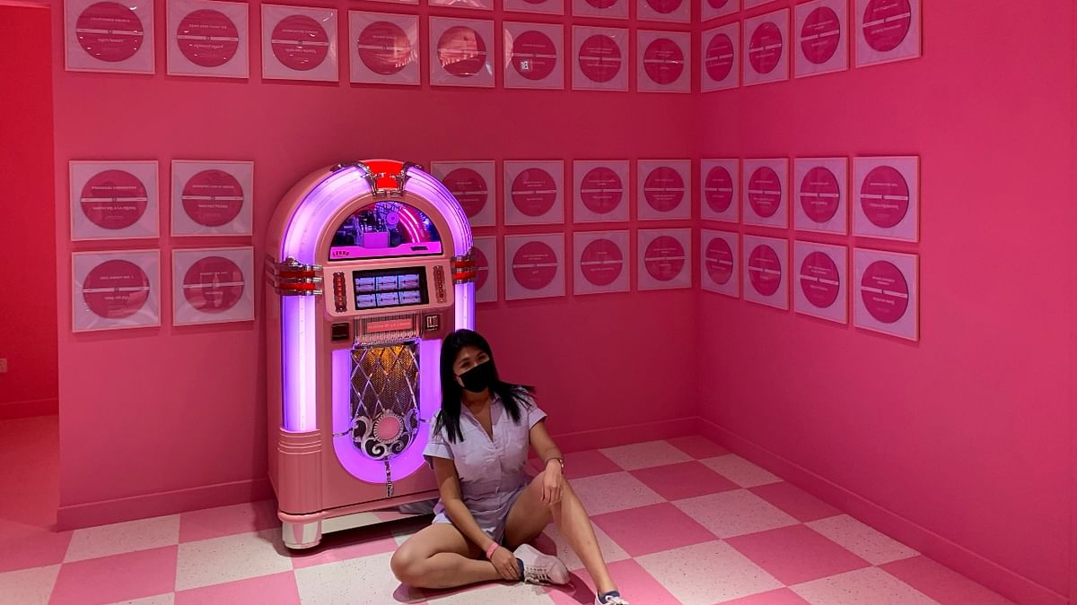 A women poses with a pink jukebox at the Museum of Ice Cream in Singapore. Credit: Reuters Photo