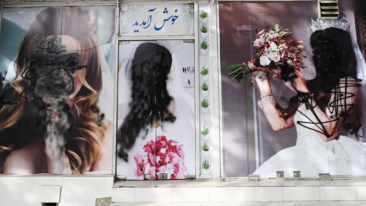 Pictures of women defaced using a spray paint in Shar-e-Naw in Kabul. Credit: AFP Photo