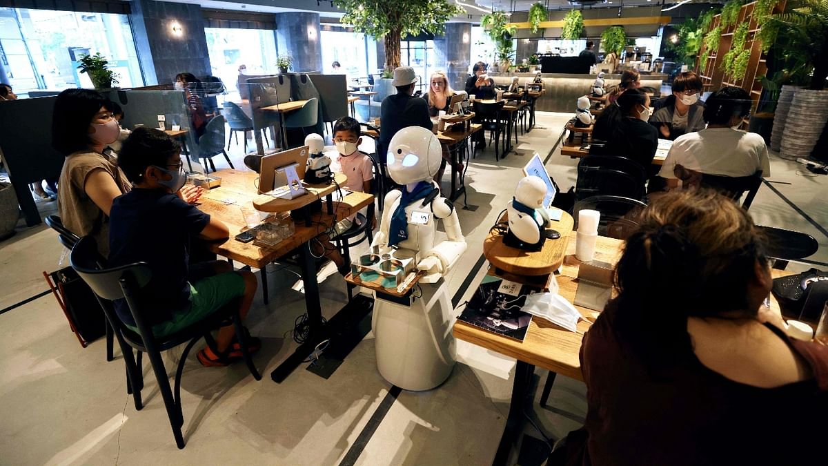 But the robots are largely a medium through which workers can communicate with customers. Credit: AFP Photo