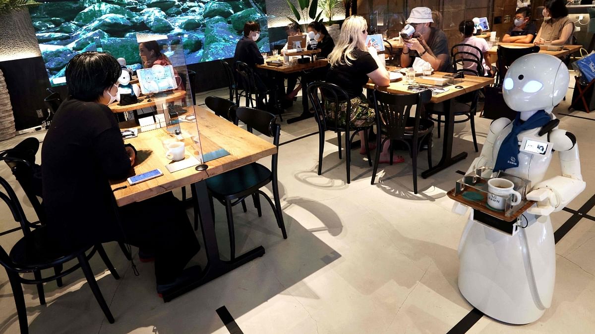 The cafe opened in central Tokyo's Nihonbashi district in June and employs staff across Japan and overseas, as well as some who work on site. Credit: AFP Photo