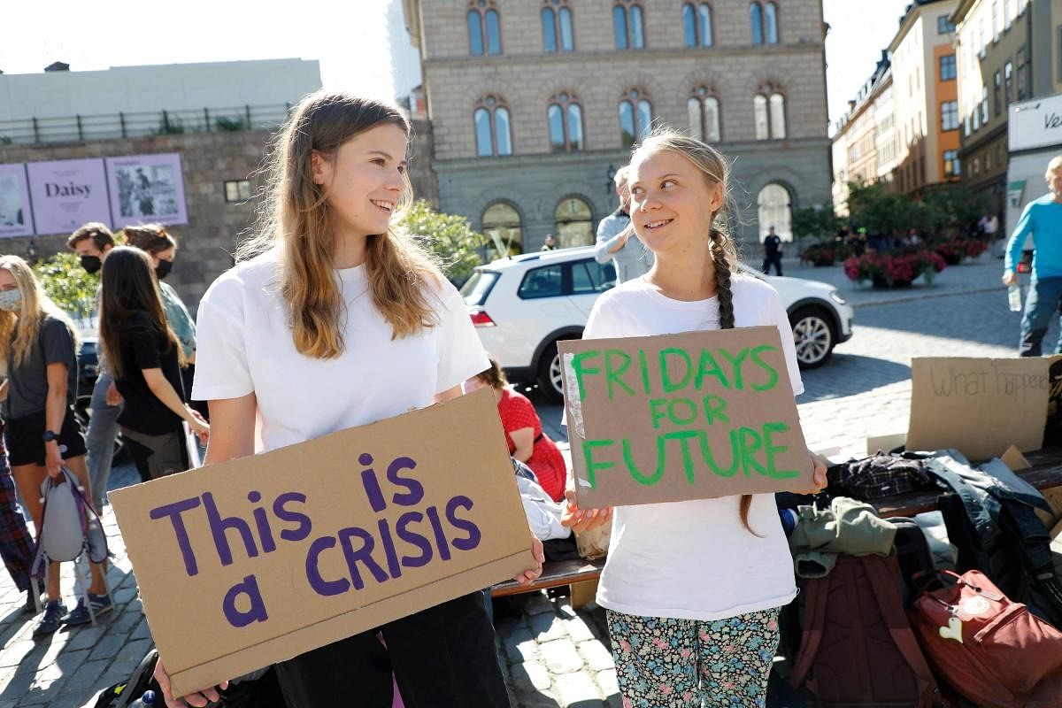 German climate activist Luisa Neubauer (L) and Swedish campaigner Greta Thunberg protest outside the Swedish Parliament during a Fridays for Future weekly demonstration, in Stockholm, Sweden. Credit: AFP Photo