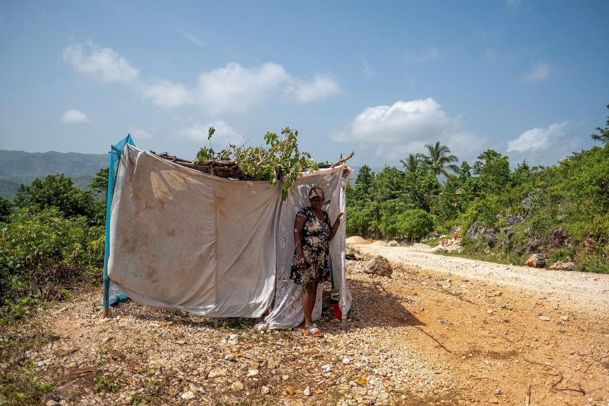 A woman stands in front of her makeshift tent at a camp built after the 7.2 magnitude quake on August 14 destroyed her house in the Nan Konsey neighborhood in Pestel, Haiti. Credit: Reuters Photo