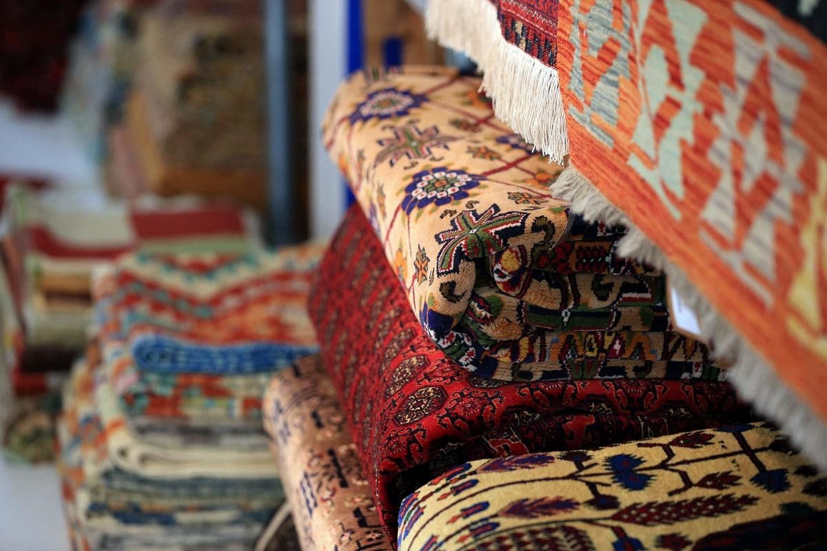 Overseas businesses selling colourful handwoven rugs and vivid handblown glass from Afghanistan fear for their suppliers, with the Taliban takeover threatening those with Western links. Credit: AFP Photo