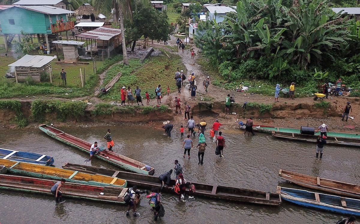 Migrants from Haiti and other countries arrive in Panamanian territory, after walking for five days in the Darien Gap. Panama and Colombia reached an agreement to control the flood of migrants crossing the common border to the United States. Credit: AFP Photo