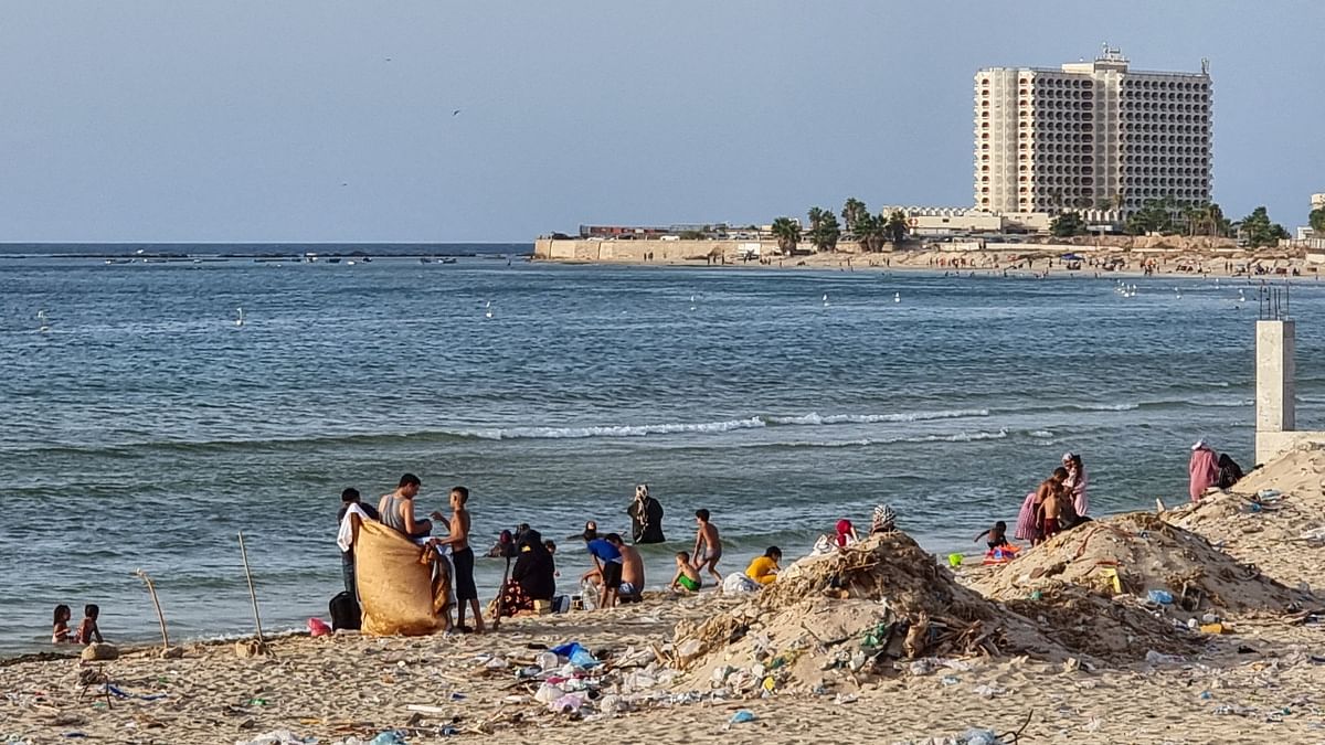 Cans, plastic bags and bottles plague the water and shore. On one beach, near a large hotel, open-air rivulets channel untreated wastewater into the sea, where a few young men brave the contaminated waters in search of cool breeze. Credit: AFP Photo