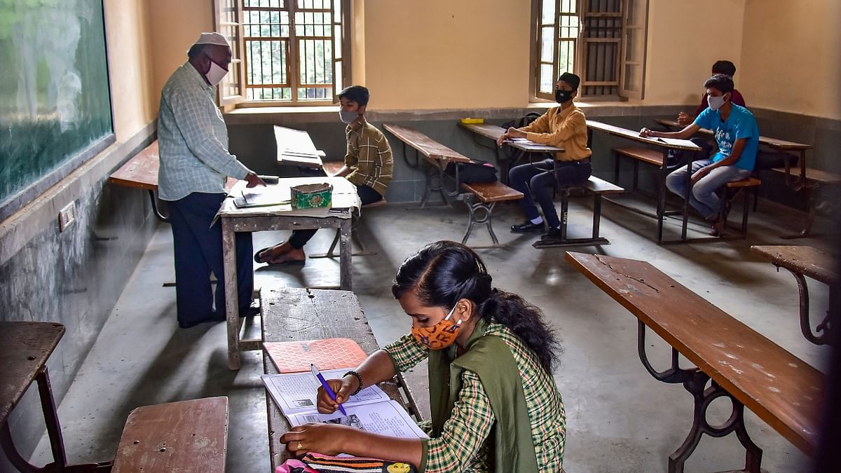 Students attend a class as the Karnataka Government allowed reopening of schools to conduct classes for 9th, 10th and Pre-University college in Bengaluru. Credit: PTI Photo