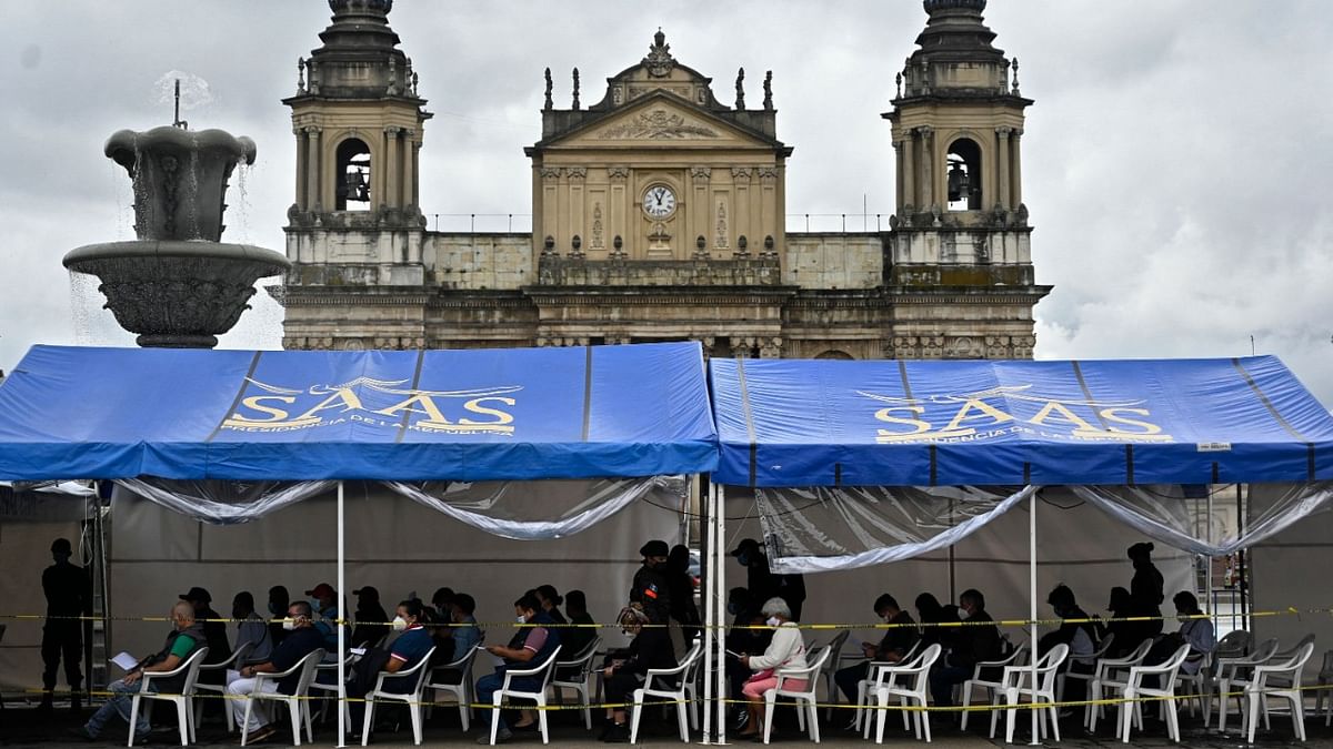 People wait to be inoculated with a dose of the AstraZeneca vaccine against Covid-19, at a vaccination center on Constitution Square, in Guatemala City, August 25, 2021, amid a spike in the number of coronavirus cases. Credit: AFP Photo