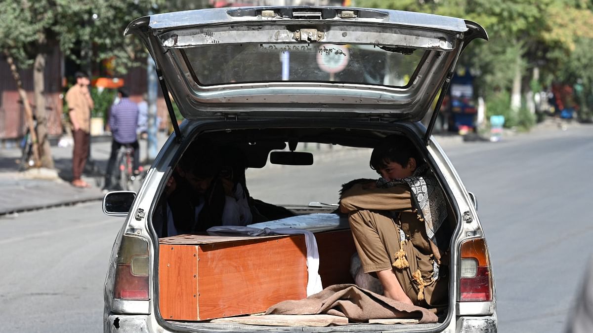 While evacuations have resumed, this young boy, along with a family member was one of scores of people in Kabul who ended up transporting the coffin of a loved one instead of fleeing the country | Credit: AFP Photo