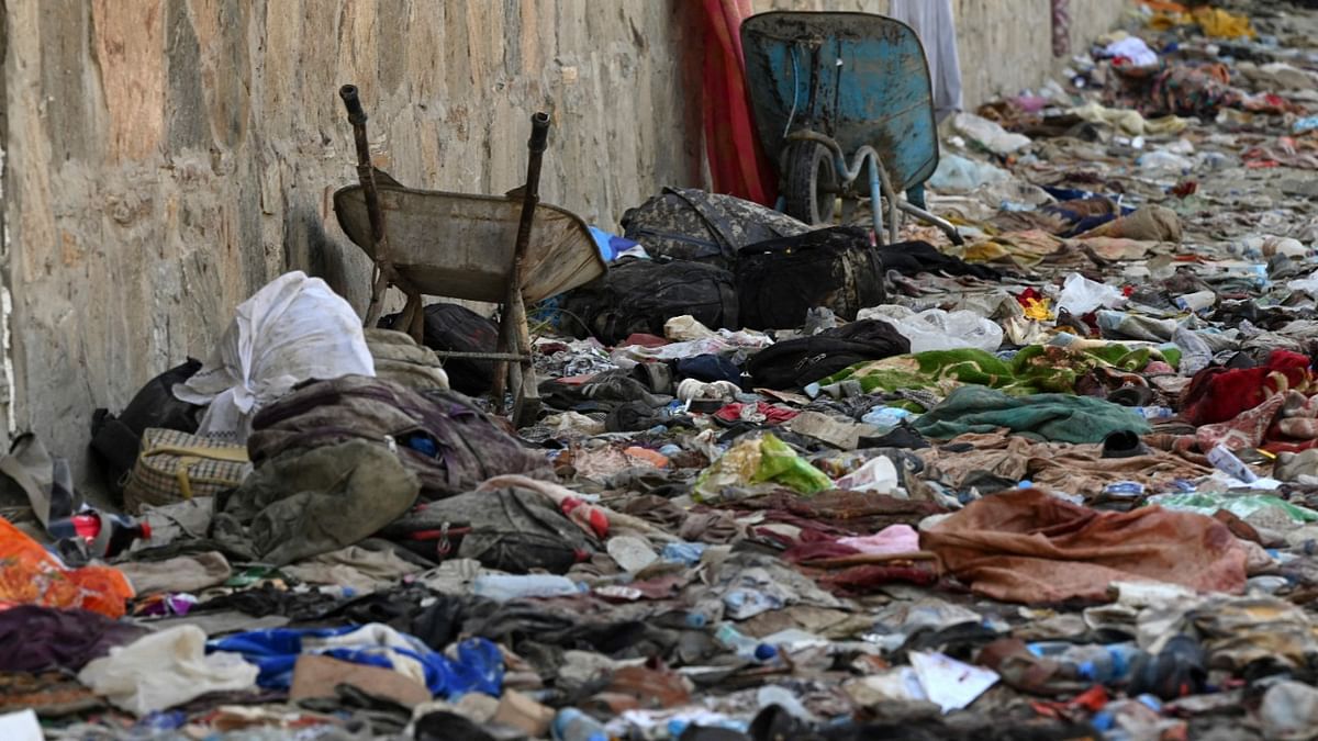 The surroundings outside the airport painted a grim picture, with backpacks and suitcases spread around the compound wall | Credit: AFP Photo