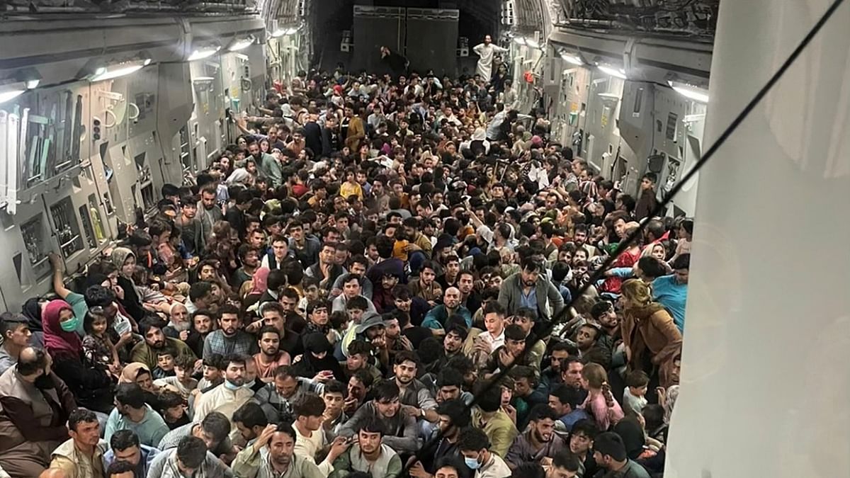 Evacuees crowd the interior of a U.S. Air Force C-17 Globemaster III transport aircraft, carrying some 640 Afghans to Qatar from Kabul, Afghanistan. Credit: Reuters Photo