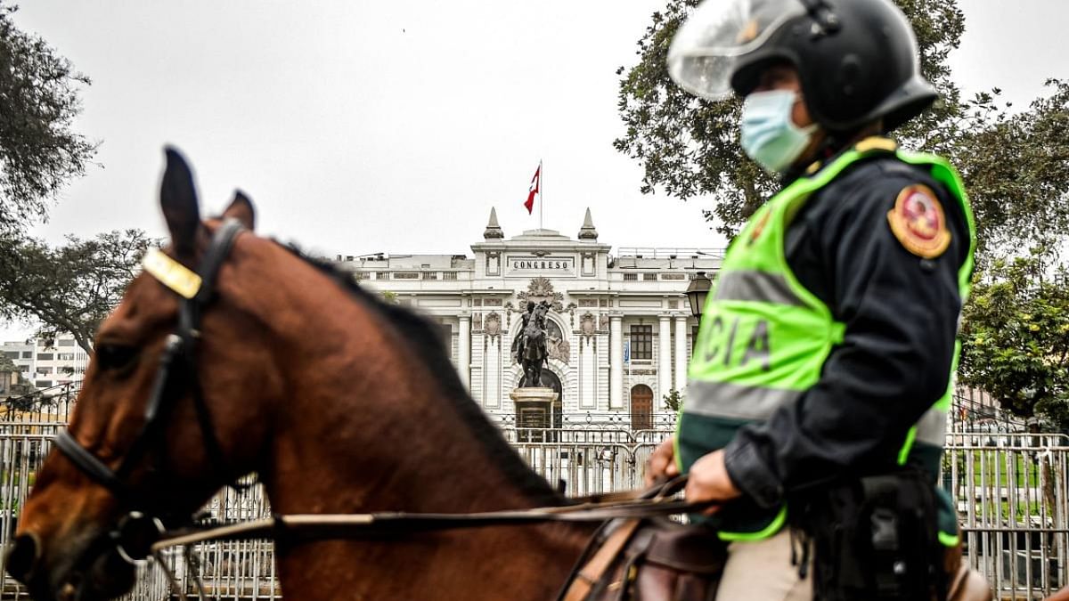 A mounted policeman stands guard outside the Congress building where lawmakers are deciding their vote of confidence in Lima on August 27, 2021. Credit: AFP Photo