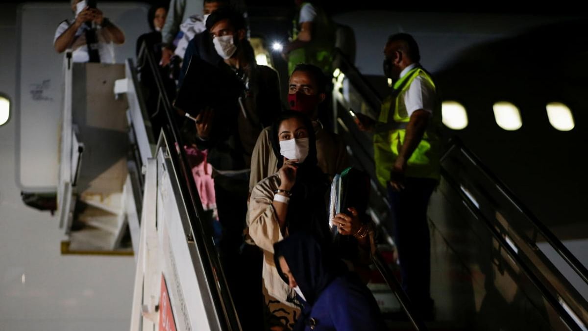 People who have been evacuated from Afghanistan arrive at Tirana International Airport, after Taliban insurgents entered Afghanistan's capital Kabul, in Tirana, Albania. Credit: Reuters photo