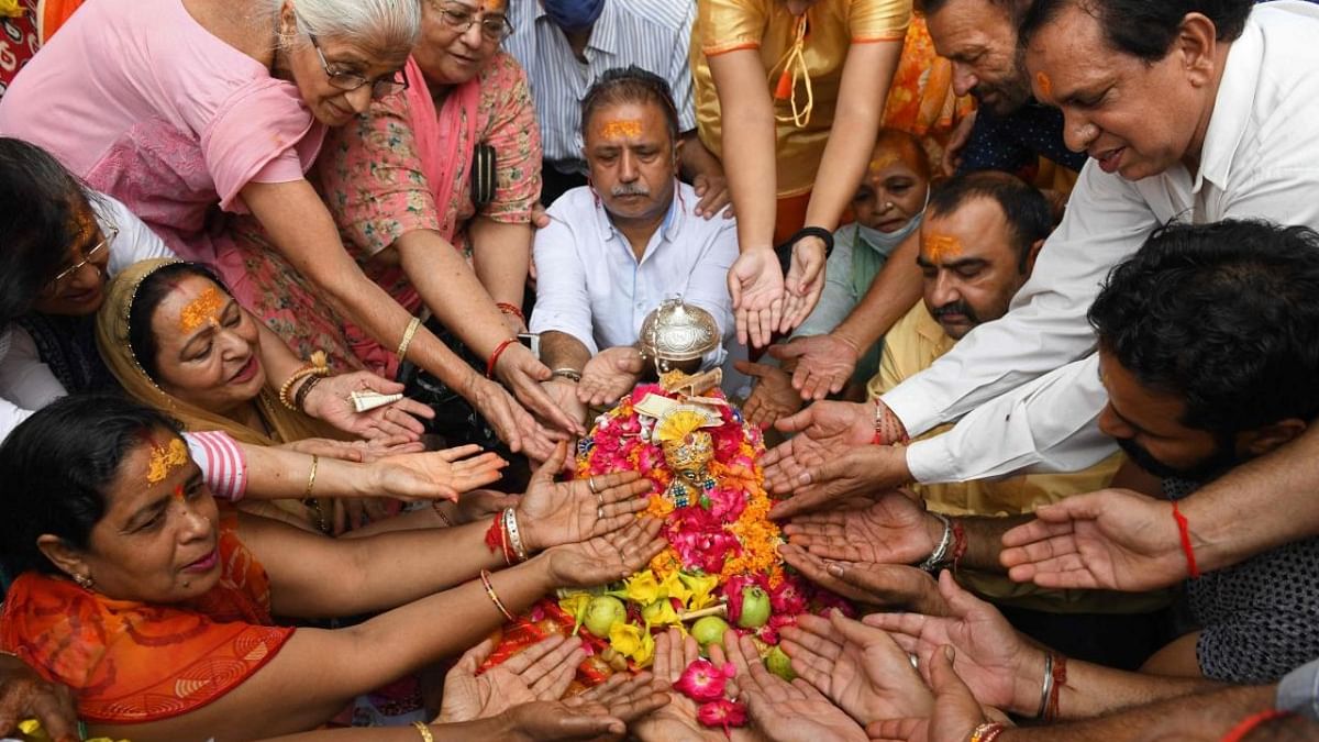 Devotees pay respect to an idol of Lord Krishna during the 'Janmashtami' festival marking the birth of Krishna at a temple in Amritsar. Credit: AFP Photo