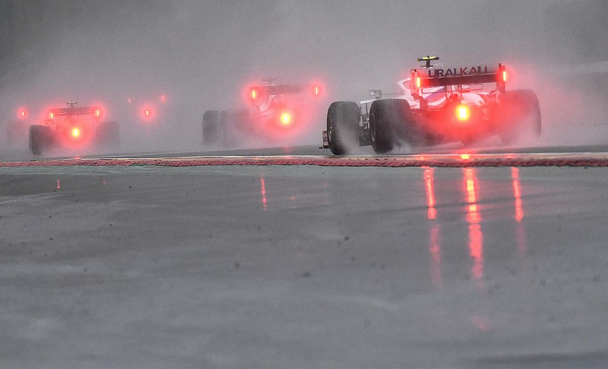 F1 dirvers drive behind the safety car during preliminary laps as the race is postponed over rainy weather during the Formula One Belgian Grand Prix at the Spa-Francorchamps circuit. Credit: AFP Photo