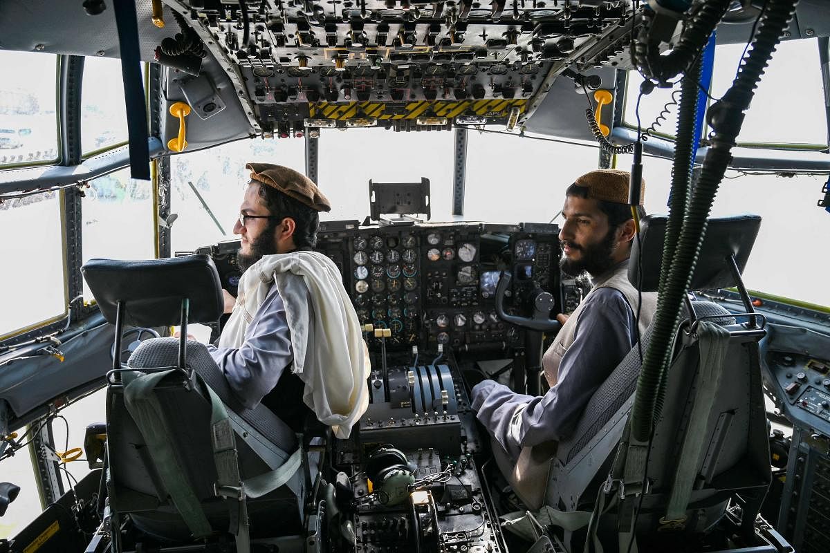 Taliban fighters sit in the cockpit of an Afghan Air Force aircraft at the airport in Kabul on August 31, 2021, after the US has pulled all its troops out of the country to end a brutal 20-year war. Credit: AFP Photo