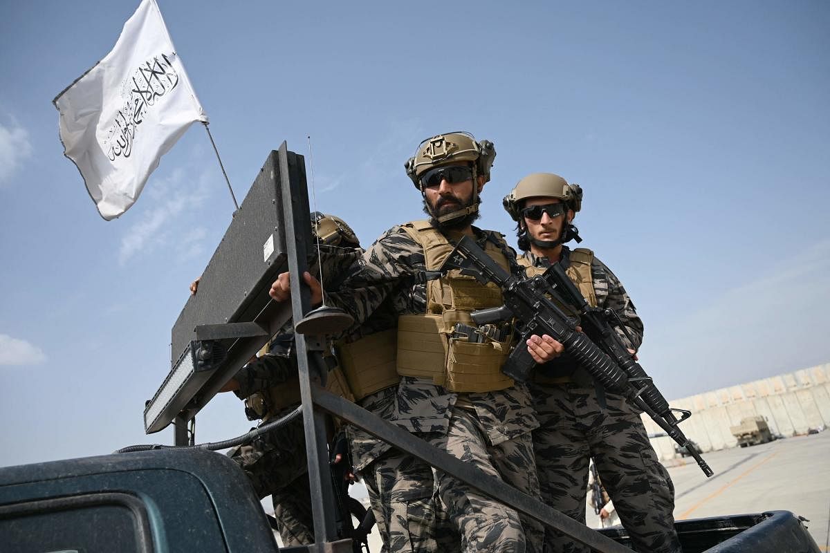 Taliban Badri special force fighters climb up on a vehicle at the airport in Kabul on August 31, 2021, after the US has pulled all its troops out of the country. Credit: AFP Photo