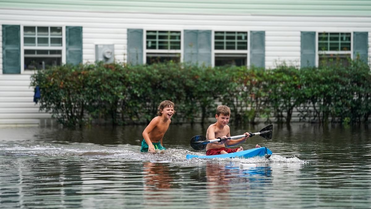 Children play in floodwater in Kiln, Mississippi. Tropical Storm Ida made landfall as a Category 4 hurricane yesterday in Louisiana and brought flooding and wind damage along the Gulf Coast. Credit: Sean Rayford/Getty Images/AFP