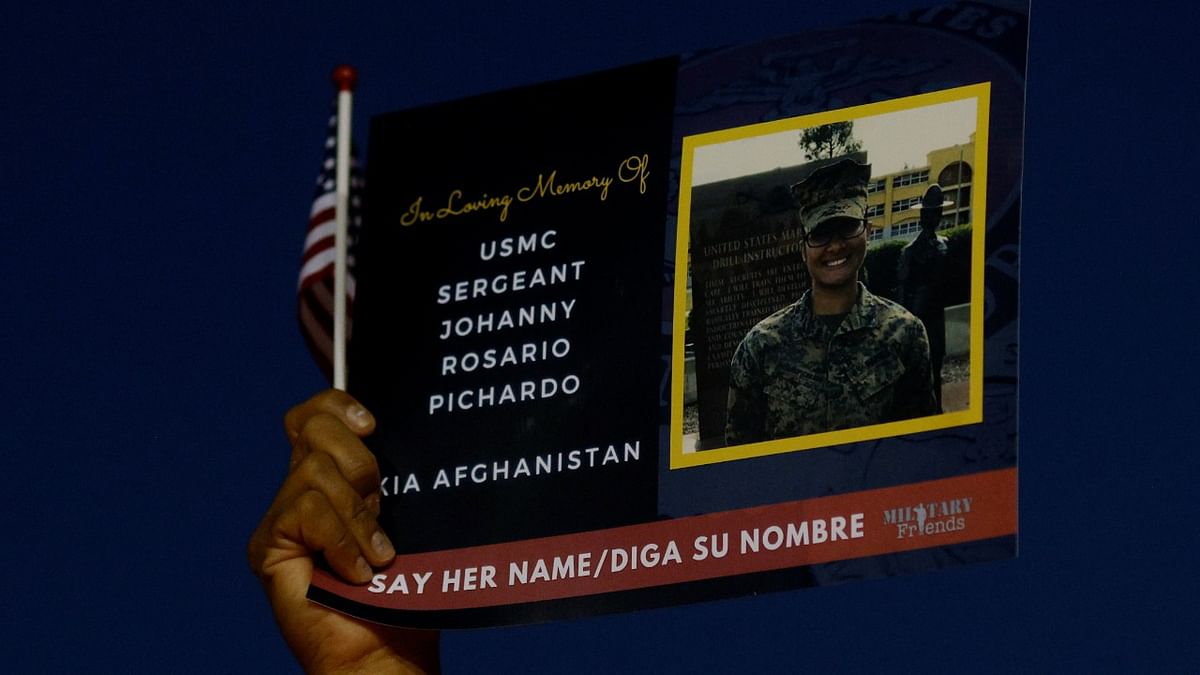 A well wisher holds a picture of Marine Corps Sgt. Johanny Rosario Pichardo during a candlelight vigil for her, who was among 13 US service members killed in the airport suicide bombing in Afghanistan's capital Kabul, in her hometown Lawrence, Massachusetts, US. Credit: Reuters Photo