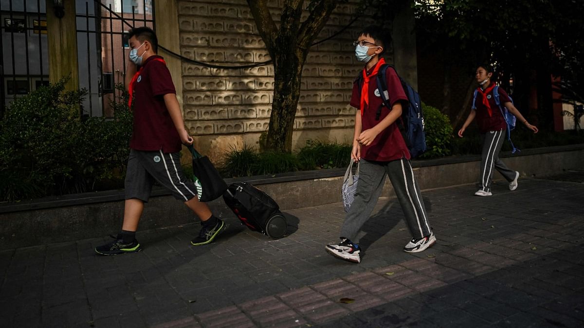 Students arrive for the first day of classes at the Shanghai Yan'an Middle, Junior and High School in Shanghai on September 1, 2021. Credit: AFP Photo