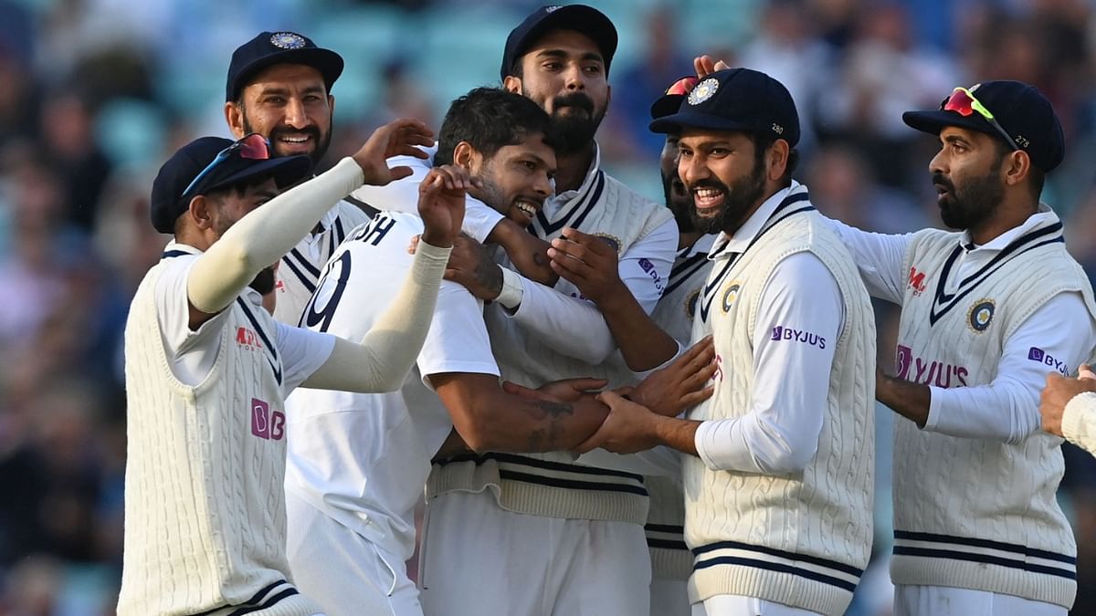 India's Umesh Yadav (C) celebrates with teammates after bowling England's captain Joe Root for 21 runs during play on the first day of the fourth cricket Test match between England and India at the Oval cricket ground in London. Credit: AFP Photo