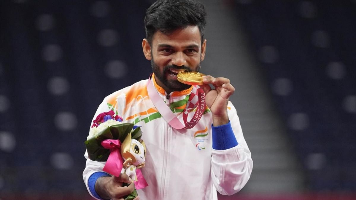 Krishna Nagar poses for photos after receiving a gold medal for men's singles SH6 gold medal badminton at the Tokyo 2020 Paralympic Games. Credit: AP Photo