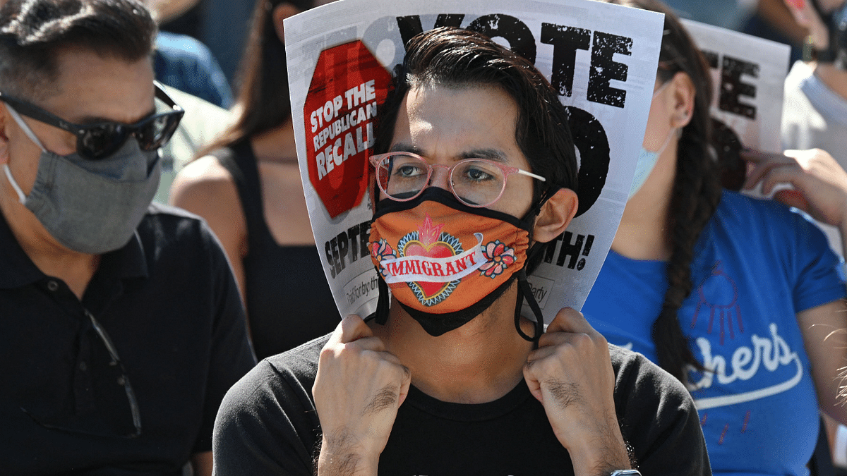 Attendees await the start of a rally against the against the upcoming gubernatorial recall election, September 4, 2021 at Culver City High School in Culver City, California. Credit: AFP Photo