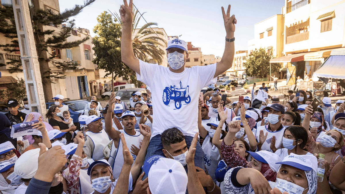Supporters of the Authenticity and Modernity Party (PAM) cheer their candidate as they gather during a campaign rally in Rabat. Credit: AFP Photo