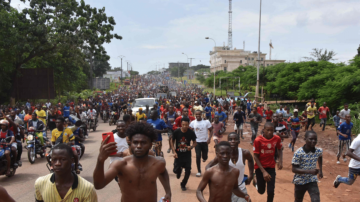 People celebrate in the streets with members of Guinea's armed forces after the arrest of Guinea's president, Alpha Conde, in a coup d'etat in Conakry. Credit: AFP Photo