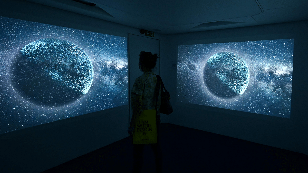 A visitor watches an installation entitled