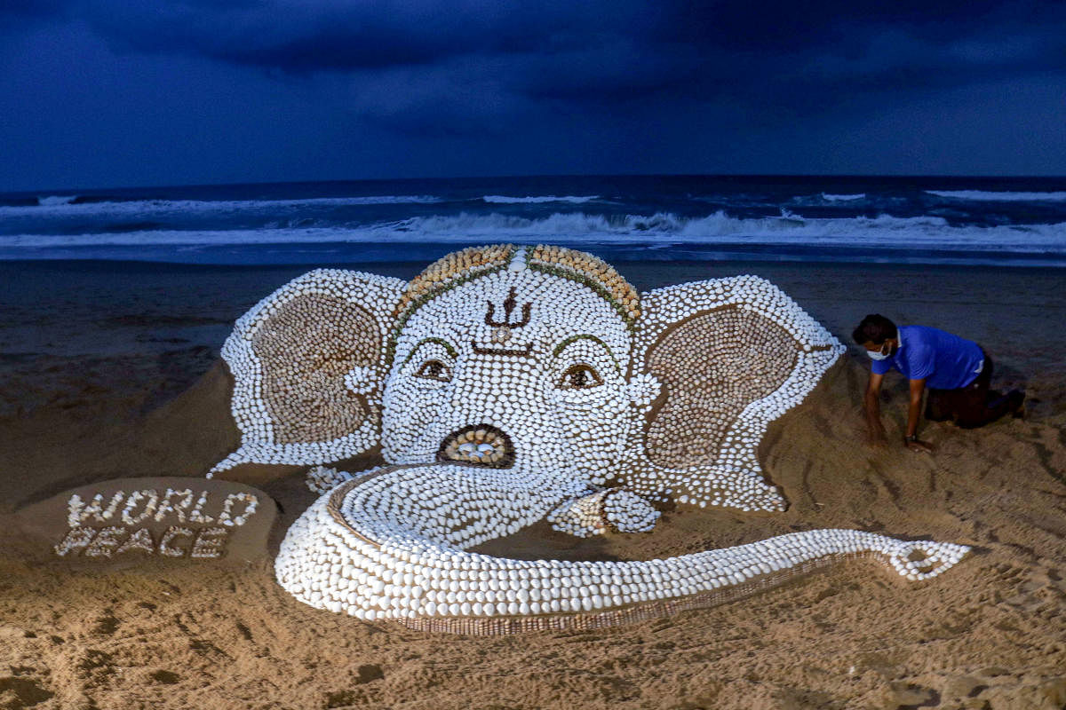A sand sculpture of Lord Ganesh by using about seven thousand sea shells with the message