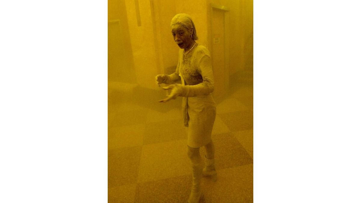 A woman covered in dust as she takes refuge in an office building following the collapse of the twin towers of the World Trade Center in lower Manhattan, New York. Credit: AFP/File Photo
