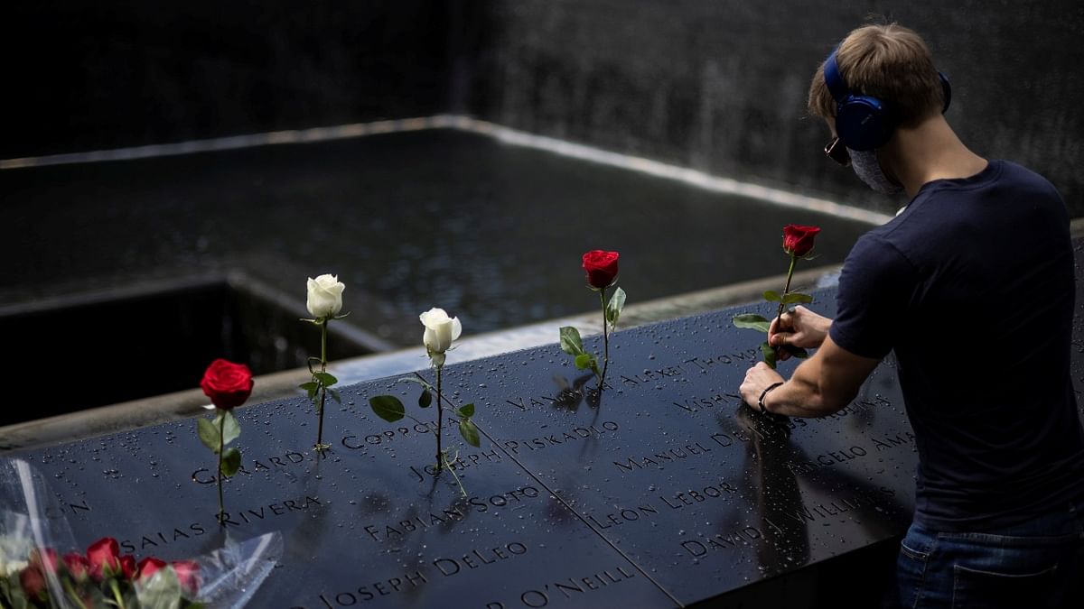A man places roses at the 9/11 Memorial ahead of the 20th anniversary of the September 11 attacks in Manhattan, New York City. Credit: Reuters Photo