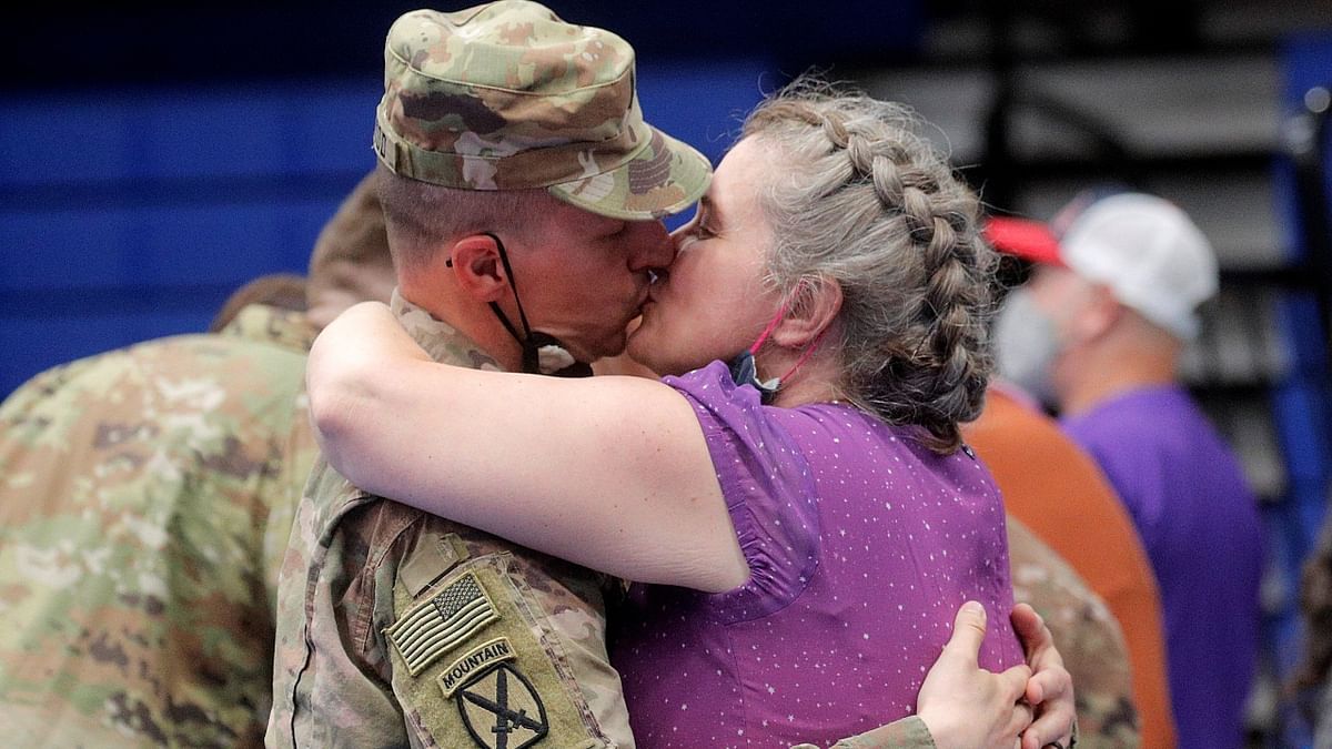 A soldier is greeted with a kiss as he returns home from Afghanistan. Credit: Reuters Photo