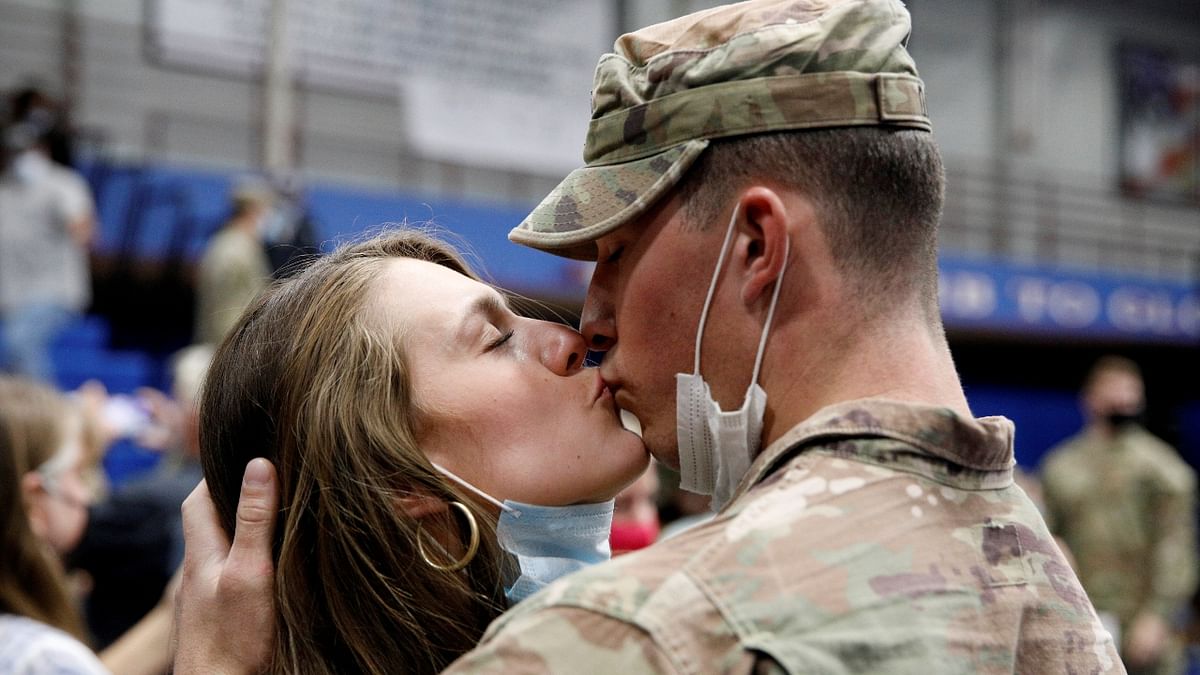 A soldier with the 4th Battalion, 31st Infantry Regiment, 2nd Brigade Combat Team of the 10th Mountain Division, receives a kiss upon returning home from deployment in Afghanistan, at Fort Drum in New York, US. Credit: Reuters Photo