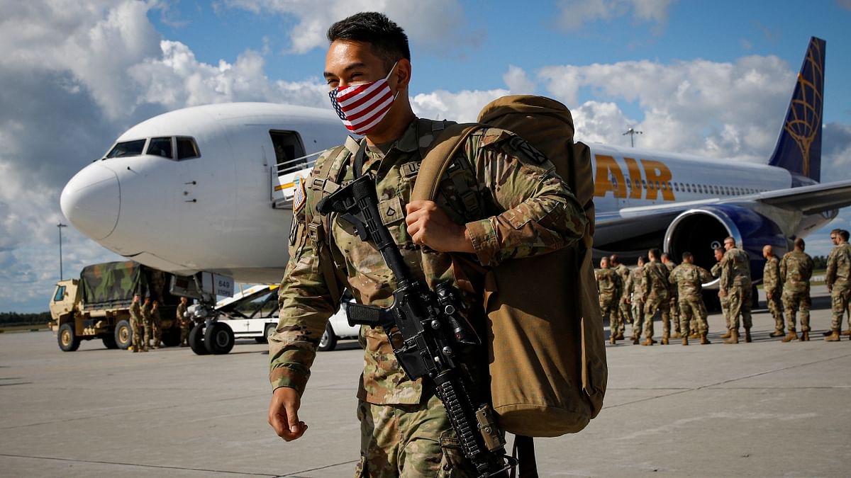 A soldier with the 4th Battalion, 31st Infantry Regiment, 2nd Brigade Combat Team of the 10th Mountain Division, is clicked on his return from Afghanistan, in US. Credit: Reuters Photo