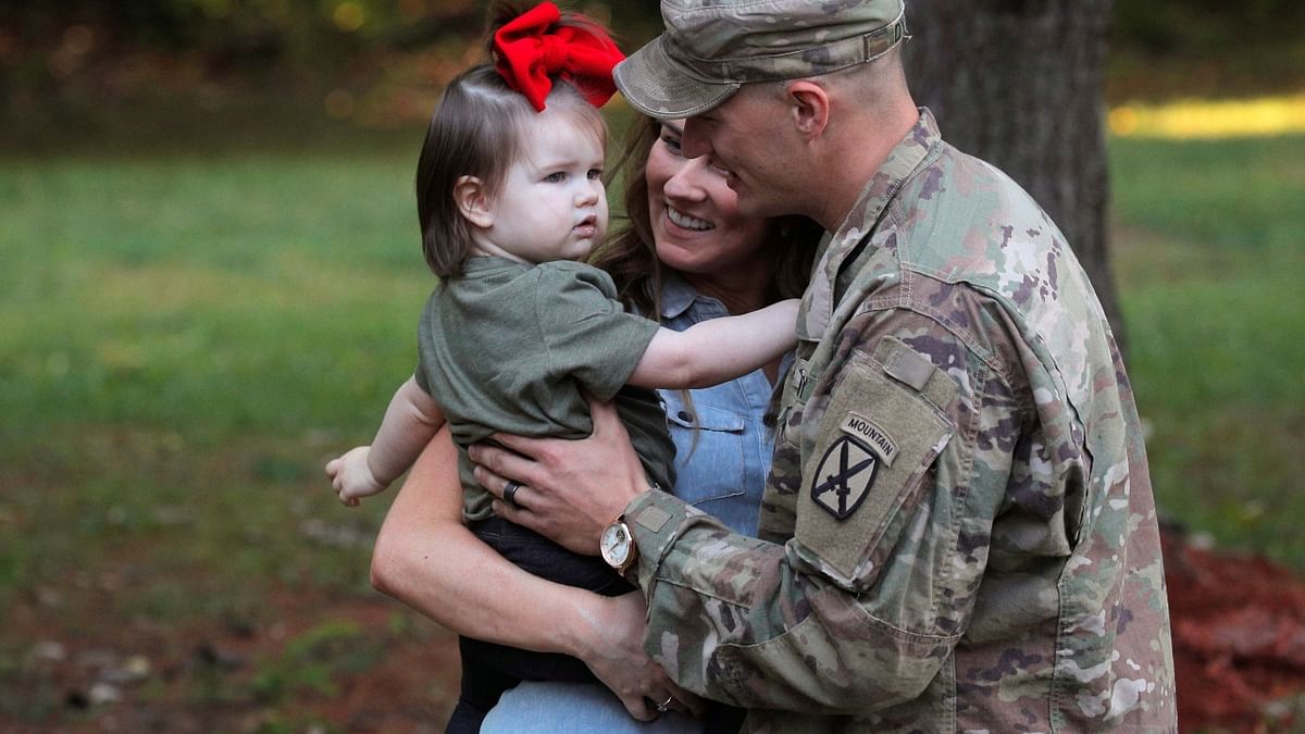 Cpl Preston Dyce, a soldier with the 4th Battalion, 31st Infantry Regiment, 2nd Brigade Combat Team of the 10th Mountain Division, meets his wife Michaela Dyce and daughter upon his return home from deployment in Afghanistan, at Fort Drum in New York. Credit: Reuters Photo