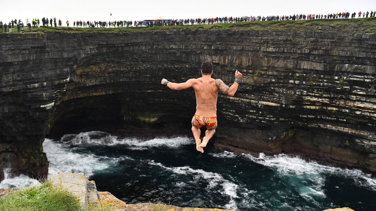 A competitor dives during the fourth round of the 2021 Cliff Diving World Series in Downpatrick Head, Ireland. Credit: Reuters Photo