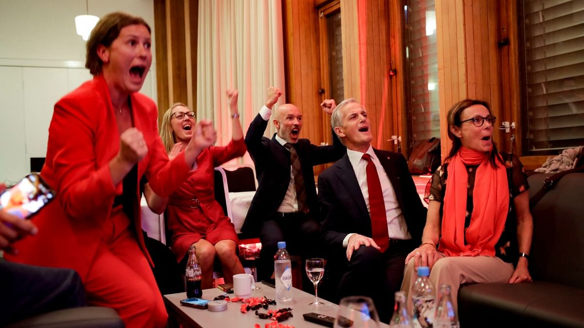 Norway's Labor leader Jonas Gahr Store (2nd R) cheers after seeing the exit poll results of the Labor Party's election event in Folkets Hus, in Oslo, during the 2021 Norwegian parliamentary elections.